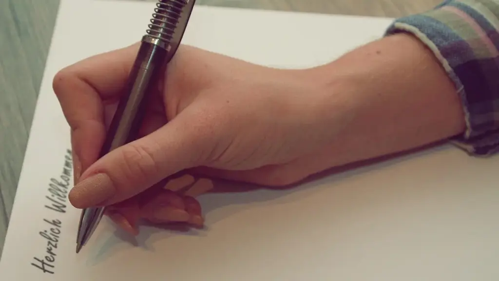 Hand writing notes on a notepad, representing segmentation and analysis of customer feedback