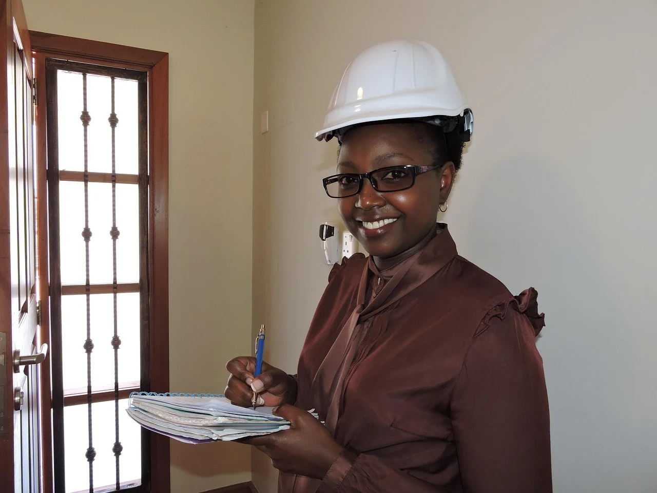 A smiling contractor holding a clipboard and checklist, representing a customer retention checklist for local service businesses