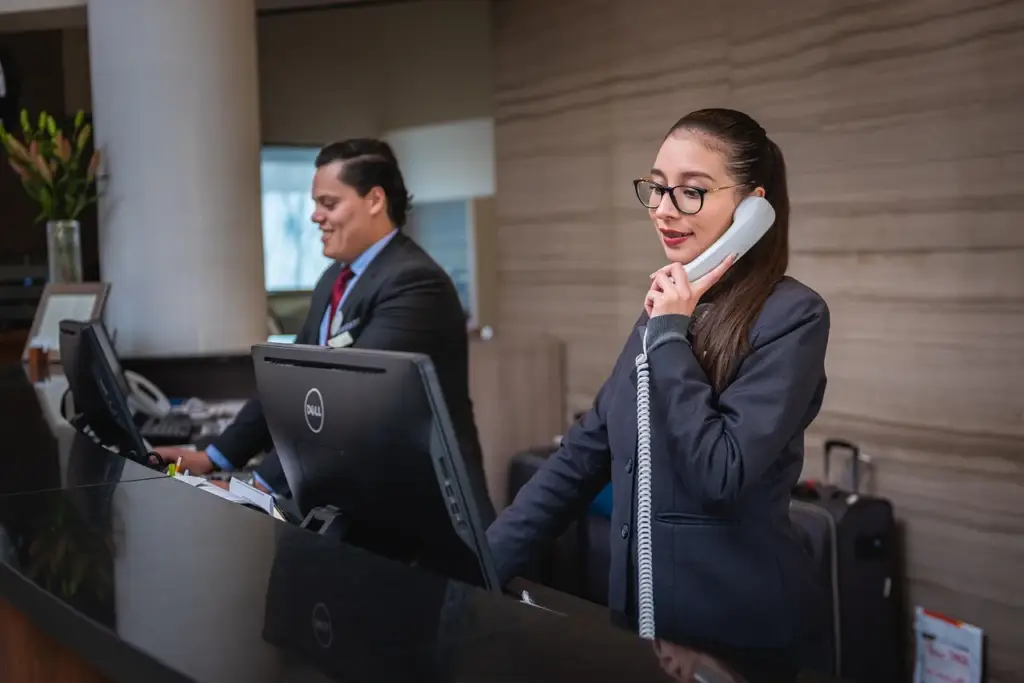 Support representative talking to a happy customer on the phone, illustrating customer retention through service